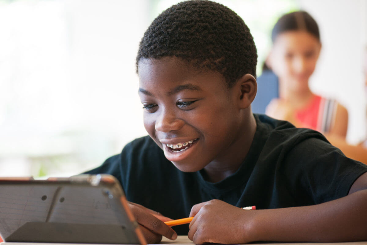 School kids in class using a digital tablet